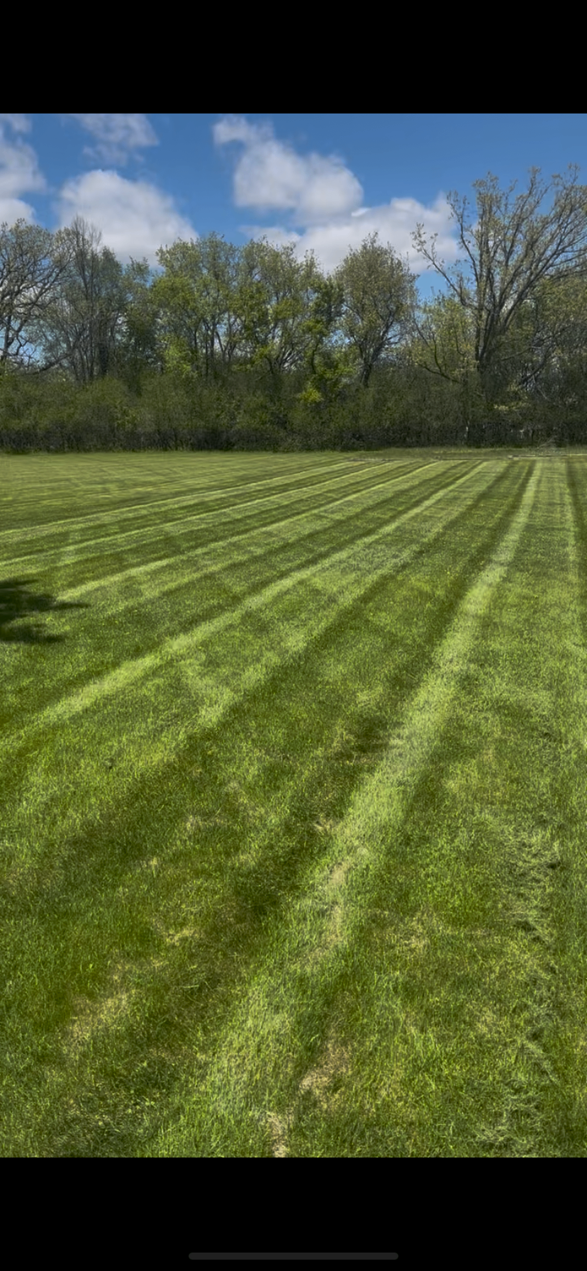 Pristine green lawn with mowing stripes in front of an Appleton, Wisconsin home